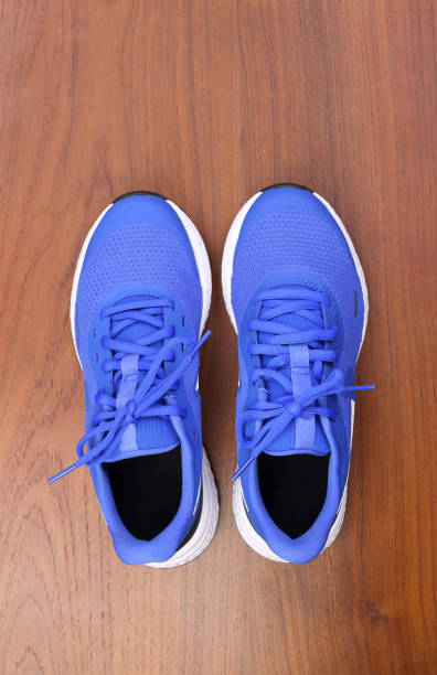 istock Top view blue running shoes on wooden background 1293638129