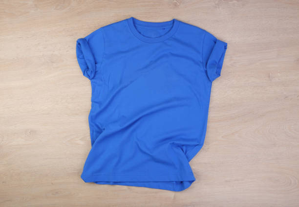 istock Blue wrinkled tshirt on wooden background 1293638145