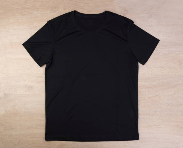 istock Black tshirt on wooden background 1293638161