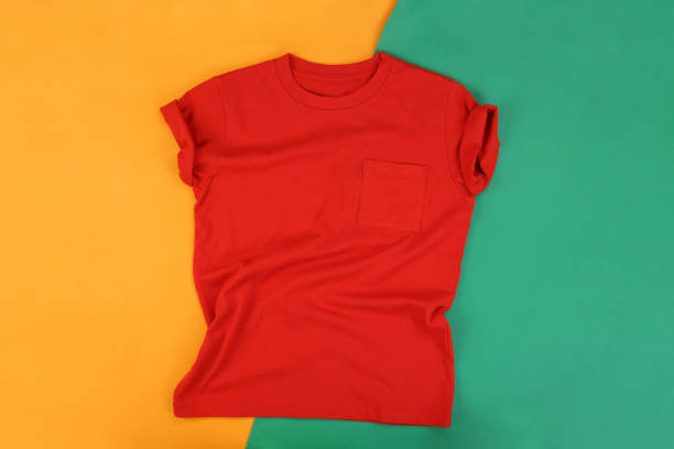 istock Orange wrinkled tshirt on green and orange background 1293638169