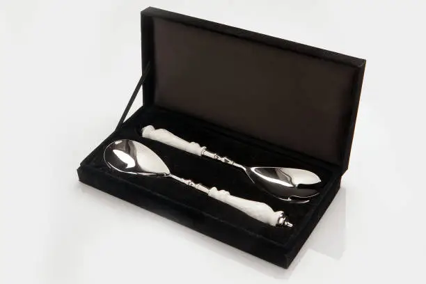 Black luxury velvet box, case including two silver tea spoons with white handles. Business present