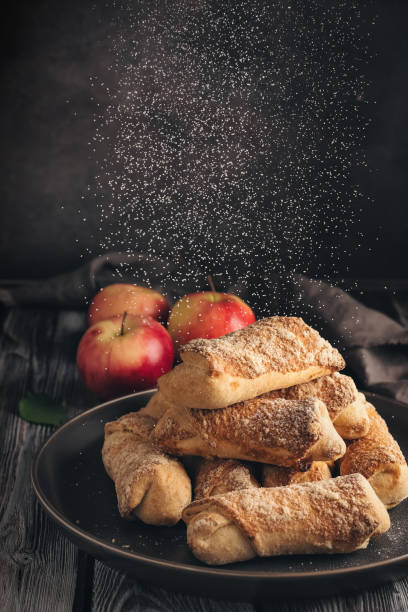 istock Apple strudel sprinkling with icing sugar, wooden dark vintage table. Selective focus. 1293642971