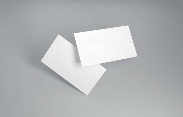Floating Business Card Mockup. Closeup on two empty business cards floating in the air in front of the grey background. 3D Illustration series sneering stock pictures, royalty-free photos & images