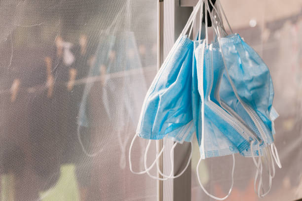 istock Many hanging surgical masks 1293647420