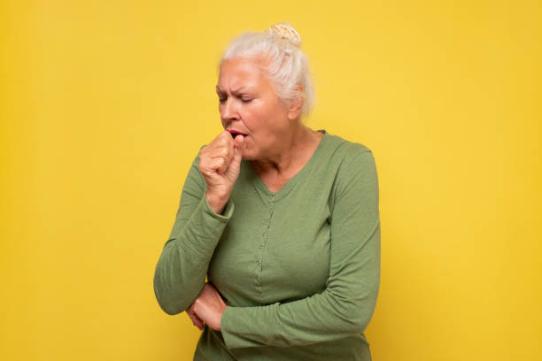 istock Senior woman feeling unwell and coughing as symptom for cold or bronchitis 1293648486