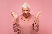 Frustrated and angry senior hispanic woman screaming.