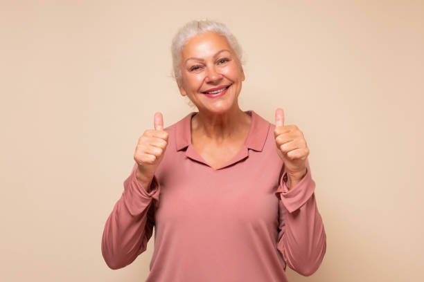 istock Active elderly woman holding her thumb up 1293649261