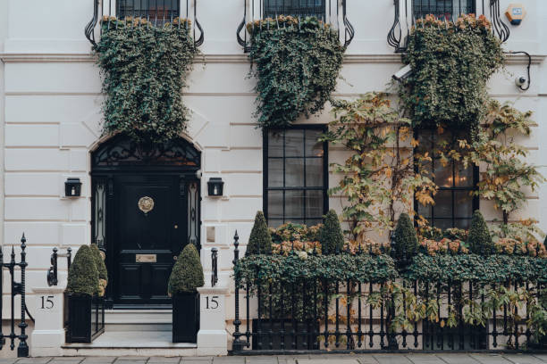 Facade of greenery covered traditional house in Mayfair, London, UK. London, UK - December 5, 2020: Facade of greenery covered traditional house in Mayfair, an affluent area in the West End of London in the City of Westminster borough. Mayfair stock pictures, royalty-free photos & images
