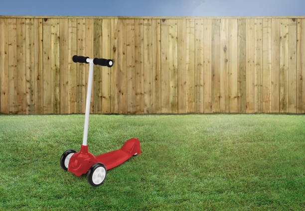 istock Red scooter on a grass in the backyard 1293650798