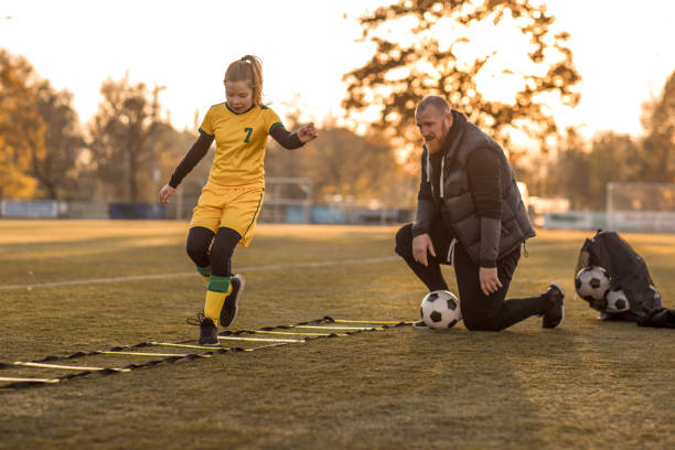 istock Soccer father coaching football daughter 1293654677