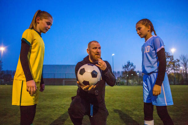 istock Soccer father coaching football daughter's team during a training session 1293655064