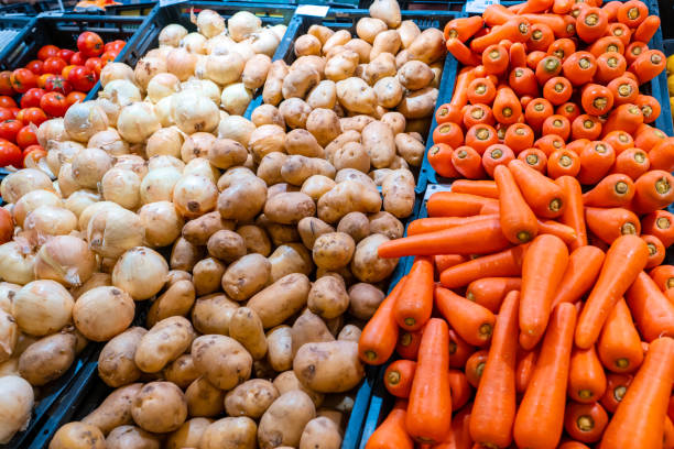 Shelves with vegetables in a grocery store.