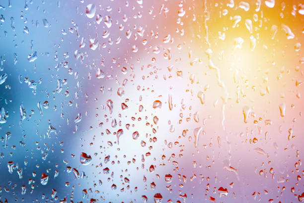 istock rain droplets on glass over calm colorful background. abstract colorful rainy backdrop 1293665454