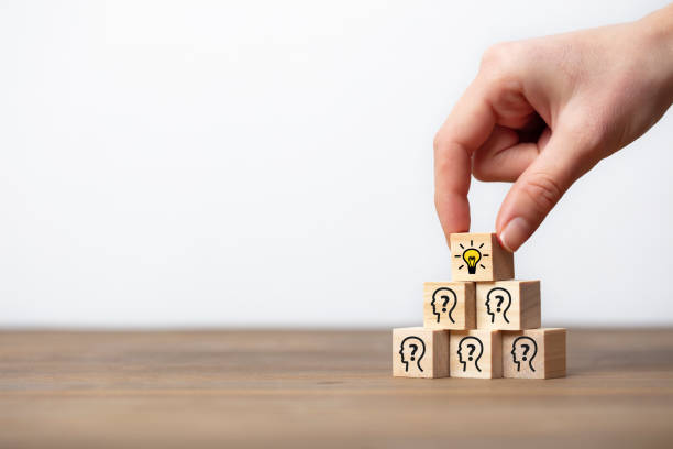 istock Concept creative idea and innovation. wooden cube block with head human symbol and light bulb icon. 1293668618