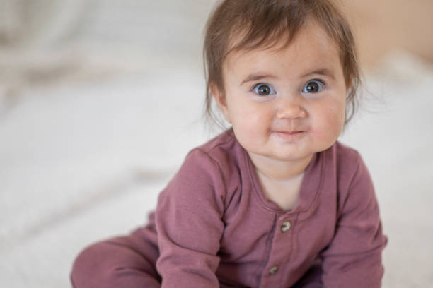 istock Cute baby girl smiles at camera 1293671264