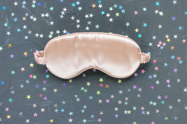 istock Pink satin eye sleeping mask and stars confetti 1293675583