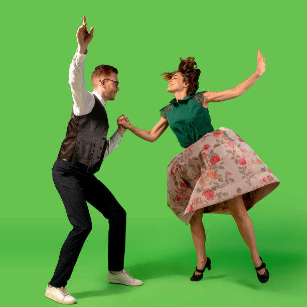istock Old-school fashioned young woman dancing isolated on green background 1293677237