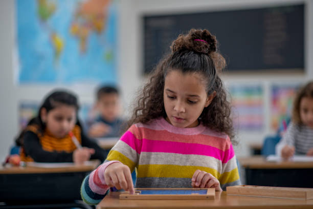 istock School girl working on her math skills 1293678187