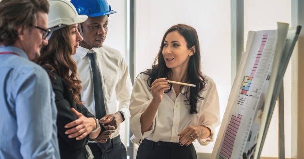 istock architecture and engineering business background of architect and engineer project development team brainstorming together with commercial tower floor plan board in architect office 1293681776
