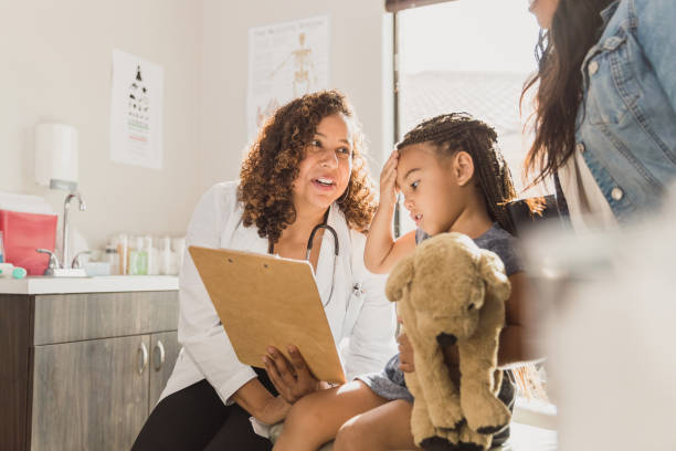 istock Pediatrician talks with patient and her mom 1293681785
