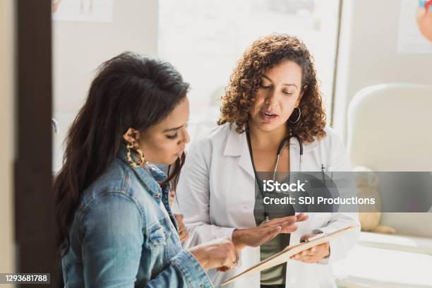 Pediatrician Talks With Patients Mother Stock Photo - Download Image Now - Doctor, Patient, Discussion