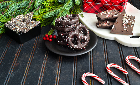 Chocolate covered pretzels with peppermint sprinkles on a table