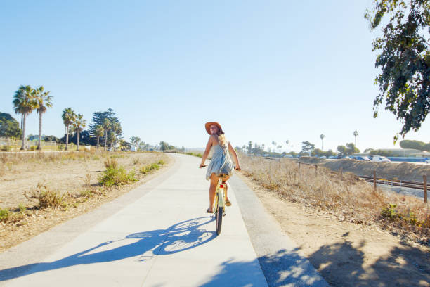 istock Woman Riding Bike 1293687277