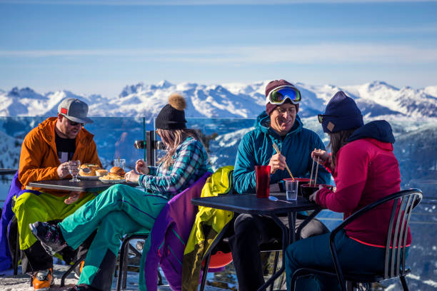 grupo de amigos disfrutando de apres-ski en la cima de la montaña whistler. - apres ski ski restaurant mountain fotografías e imágenes de stock