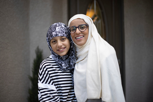 A portrait of a mother and daughter with a hijab on.
