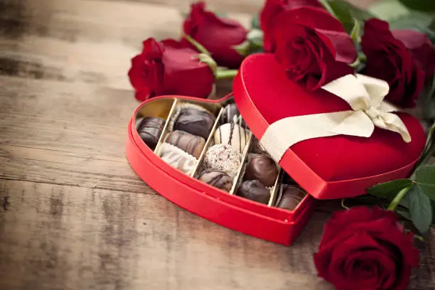 Photo of Valentine's Day Box of Chocolates and Red Roses