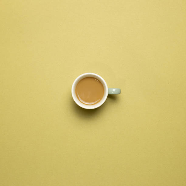 istock Cup of coffee on khaki background. top view, copy space 1293701004