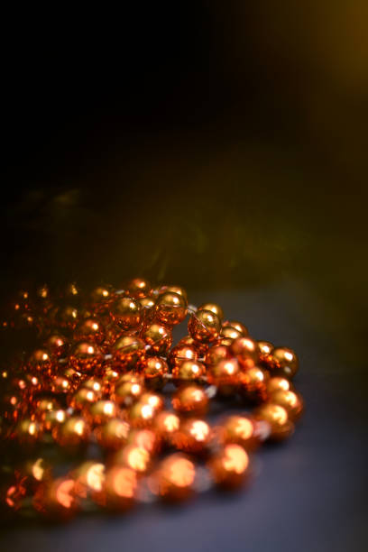 istock Orange beads with round beads for decorating the Christmas tree, close-up on a dark background. 1293705930
