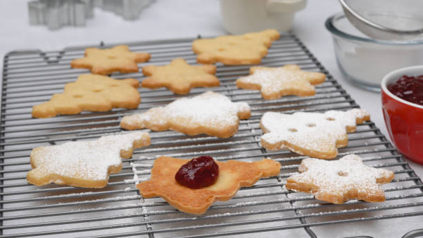 istock Christmas shortbread cookies with raspberry jam recipe, close up baking process. Baked cookies close up on cooling rack 1293707732