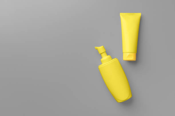 istock Yellow cosmetic container on gray background top view 1293708394