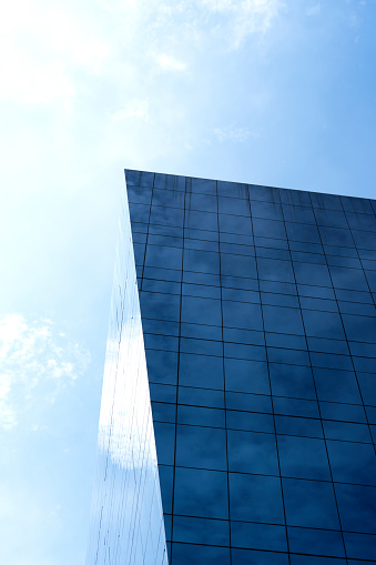 Closeup modern corporate glass building with reflection of the city, background with copy space, full frame horizontal composition