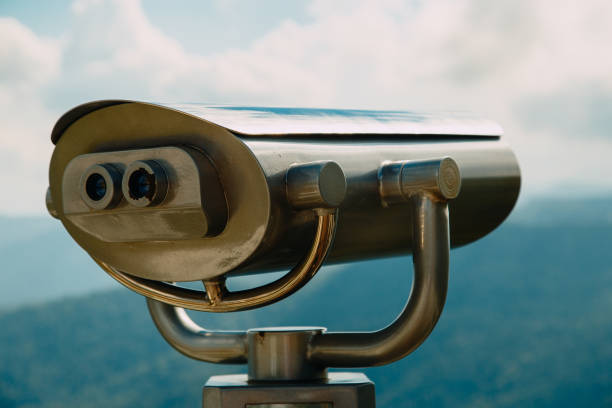 istock Binoculars with coins overlooking the Blue Mountains, Landscape with beautiful cloudy sky and mountains .. 1293710132