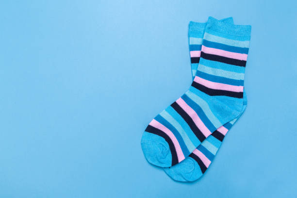 istock blue new socks stacked on a blue background. top view. place for text. 1293710295