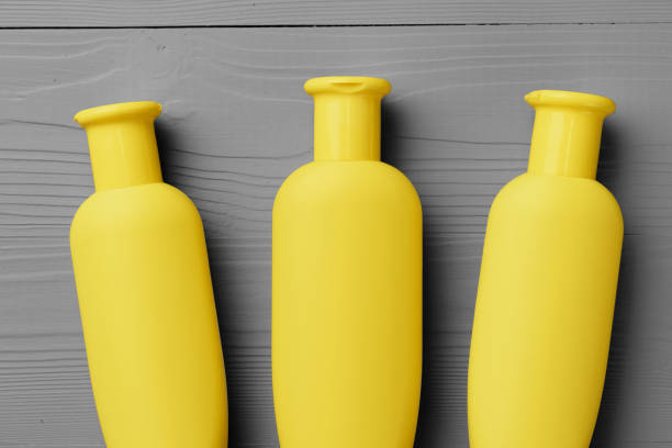 istock Yellow cosmetic container on gray background top view 1293711851