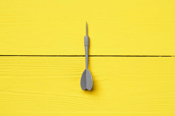 istock Gray dart arrow on yellow background copy space 1293712194