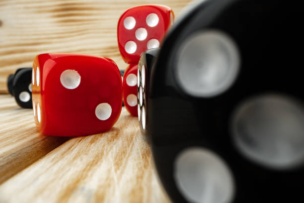 istock Red and black dice cubes on wooden background 1293718376