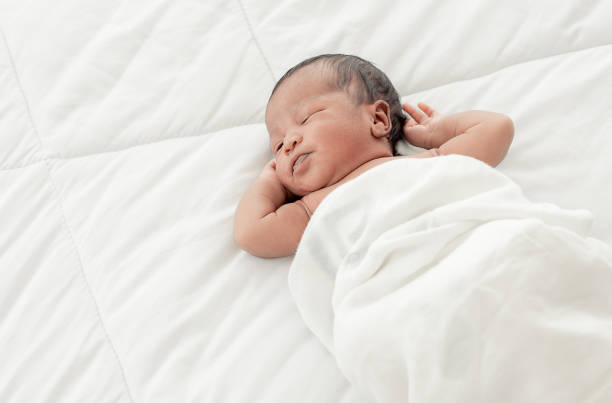 istock Portrait of african infant sleeping on bed 1293719983