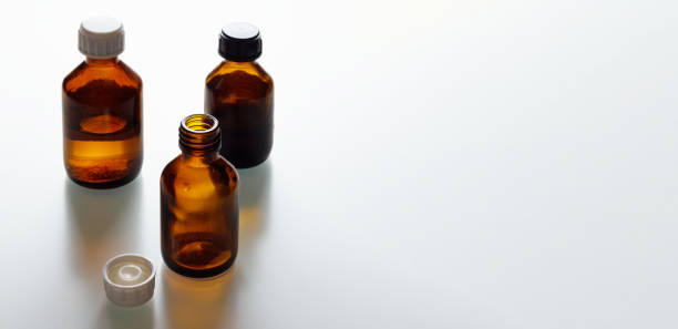 istock Three dark brown medical bottles on the table 1293720150