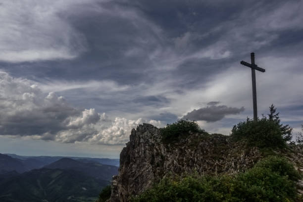 istock summit cross on a mountain with beautiful clouds on the sky 1293720165