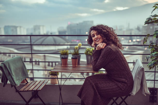 istock Cute Female Relaxing On Home Rooftop Balcony 1293720715