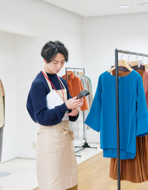 istock Asian clothing sales assistant checking the items 1293721865