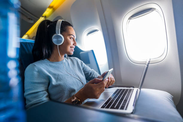 istock Young female freelancer enjoys her flight 1293724681