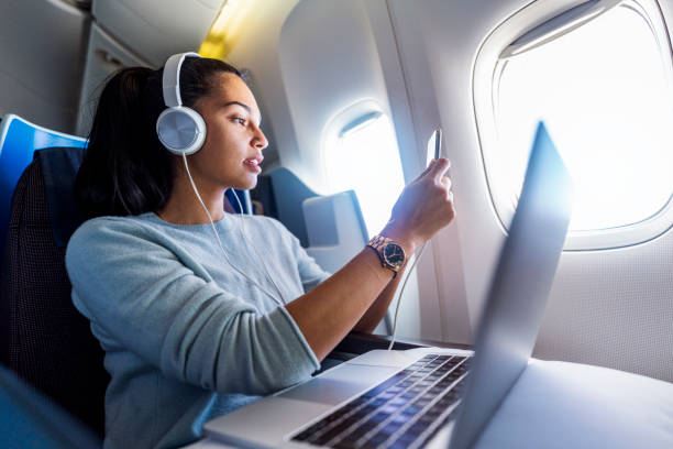 istock Young female freelancer enjoys her flight 1293725384