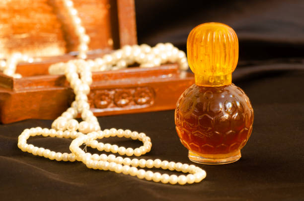 Vintage decorative small bottle of attar perfume or cologne on Black background