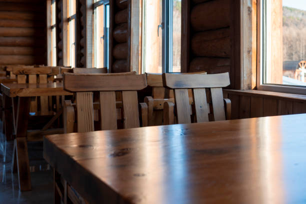 istock Wooden table and chairs by the window in a restaurant 1293728677