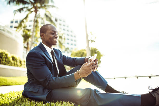 istock man sitting on the park text messaging in miami 1293734576